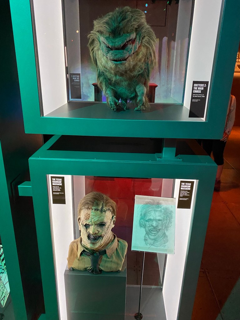 Two displays. One of Leatherface's mask, and the Critter from the movie Critters 2.