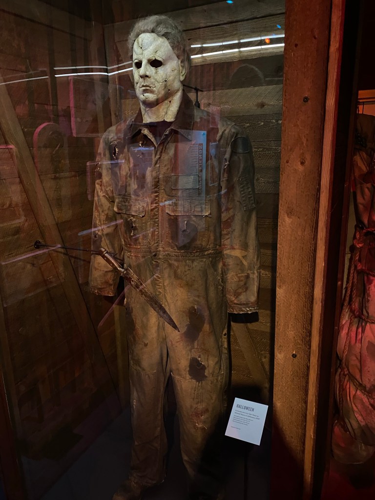 Horror display of Michael Myers inside of a glass display.