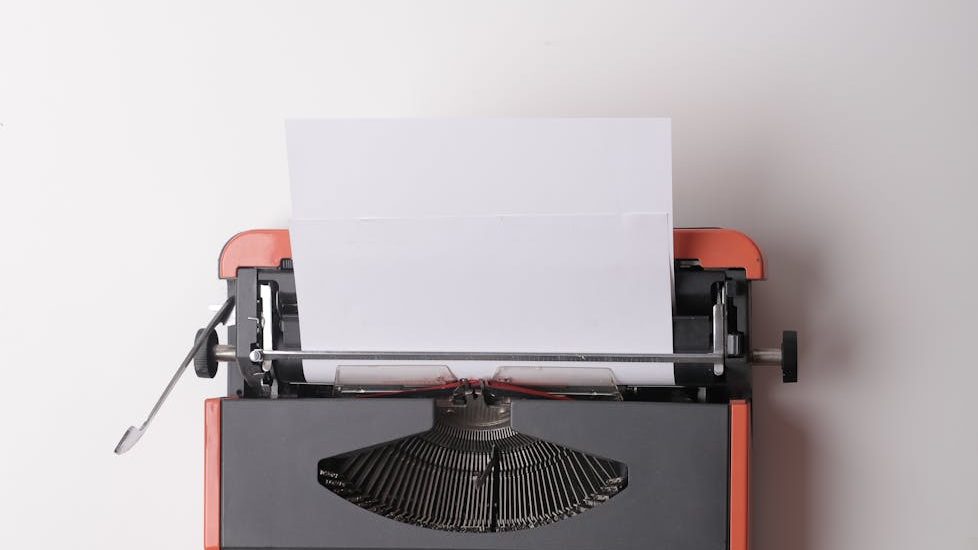 A typewrite with a blank page ready to be typed.