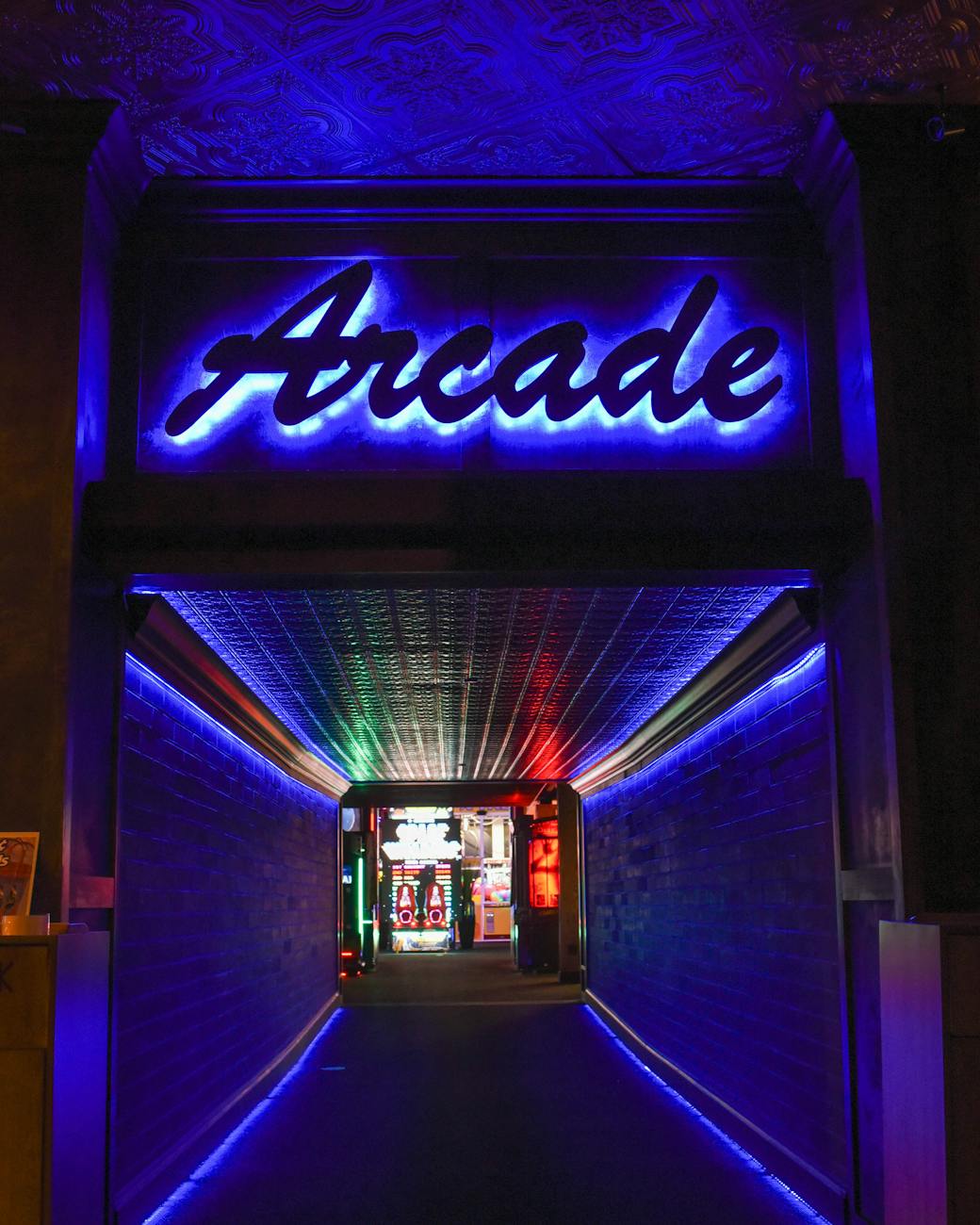 An entrance to an arcade with the sign reading "Arcade" above the hallway.
